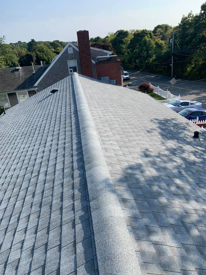 A close up of a roof with a chimney on it.