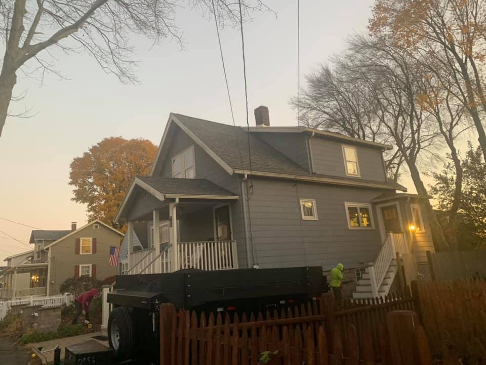 A house with a trailer parked in front of it