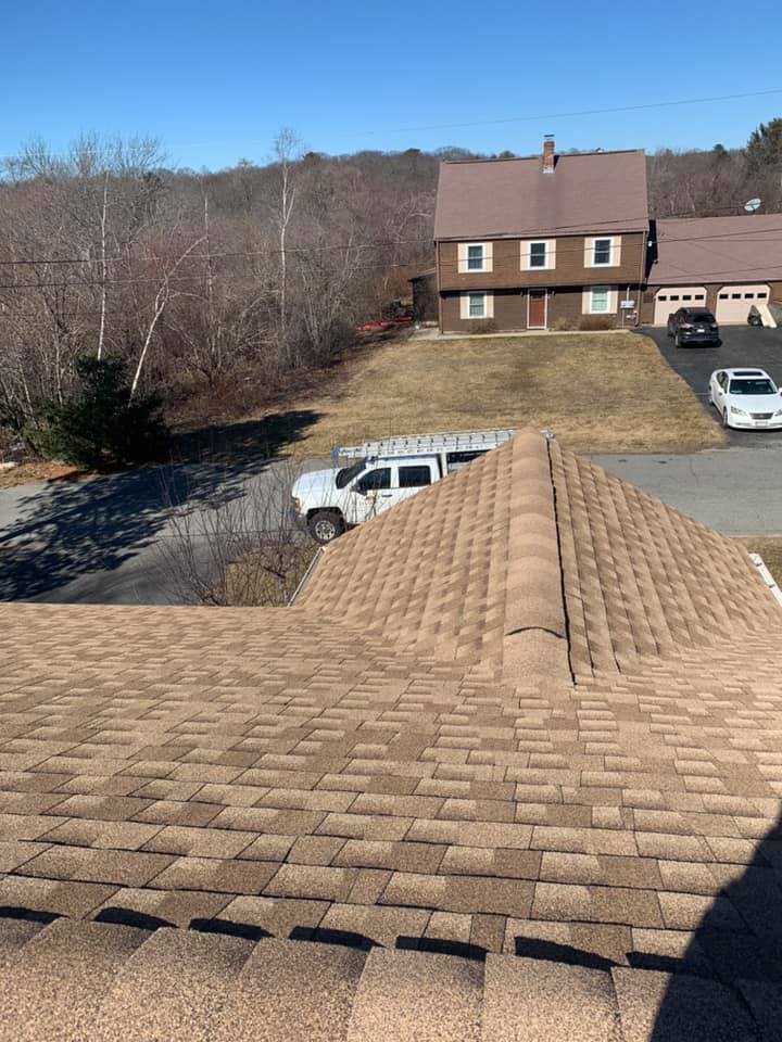 A truck is parked on the roof of a house.