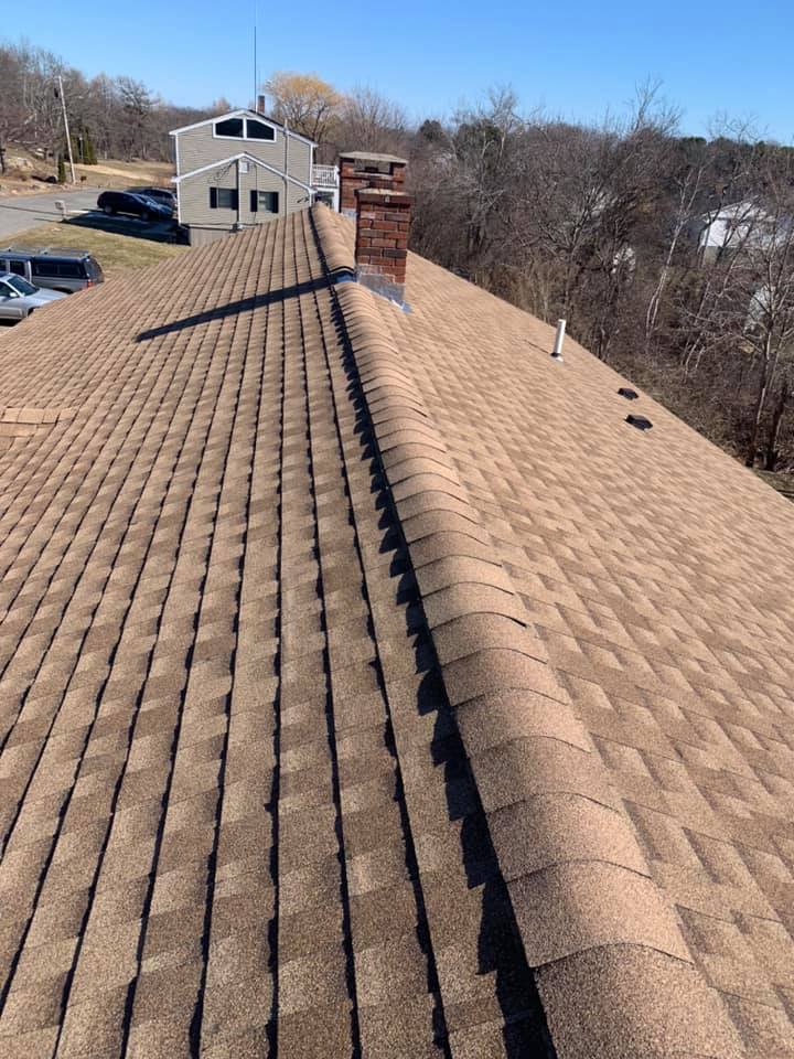 The roof of a house with a chimney on top of it.