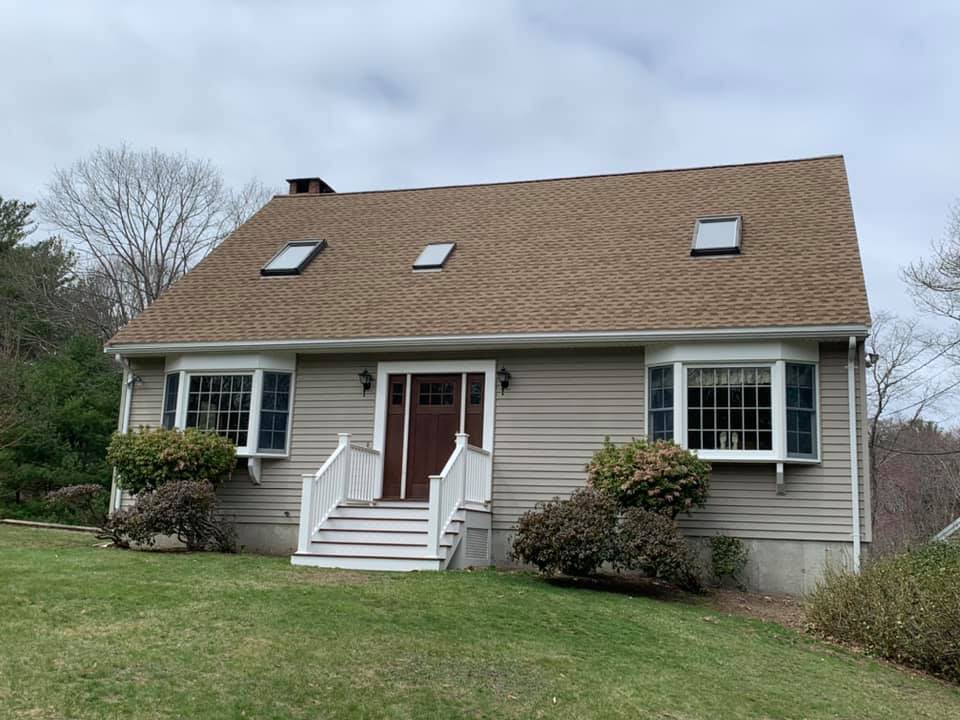 A house with a brown roof and a lot of windows