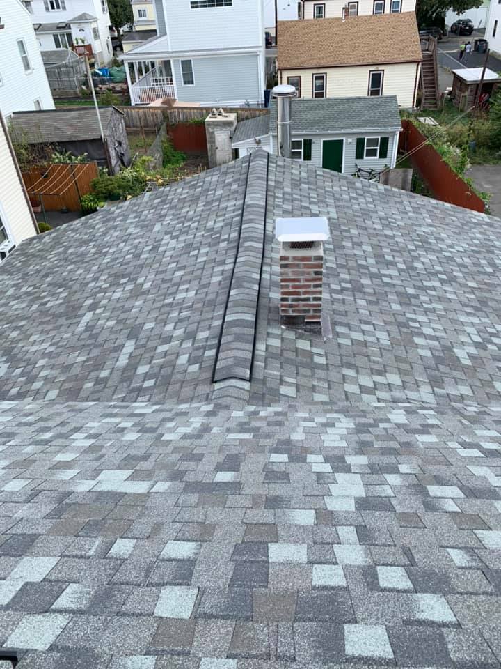 An aerial view of a roof with a chimney on it.