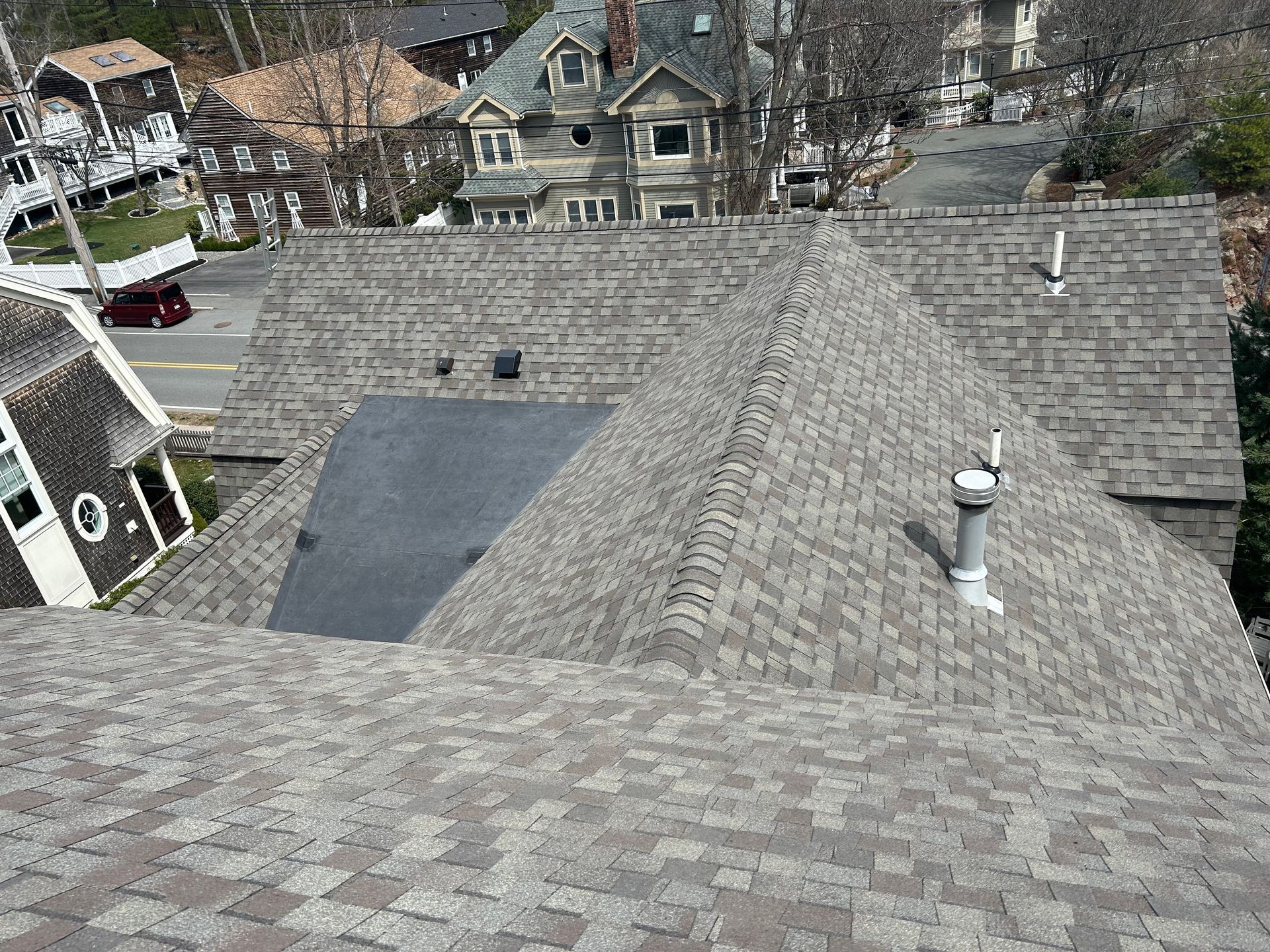 An aerial view of a house 's roof with a chimney on it.