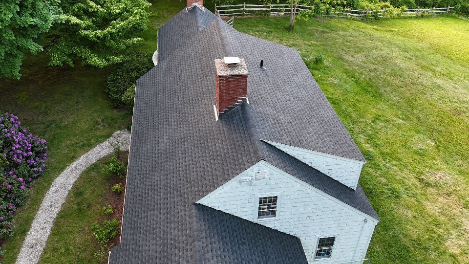 An aerial view of a house with a chimney on the roof.