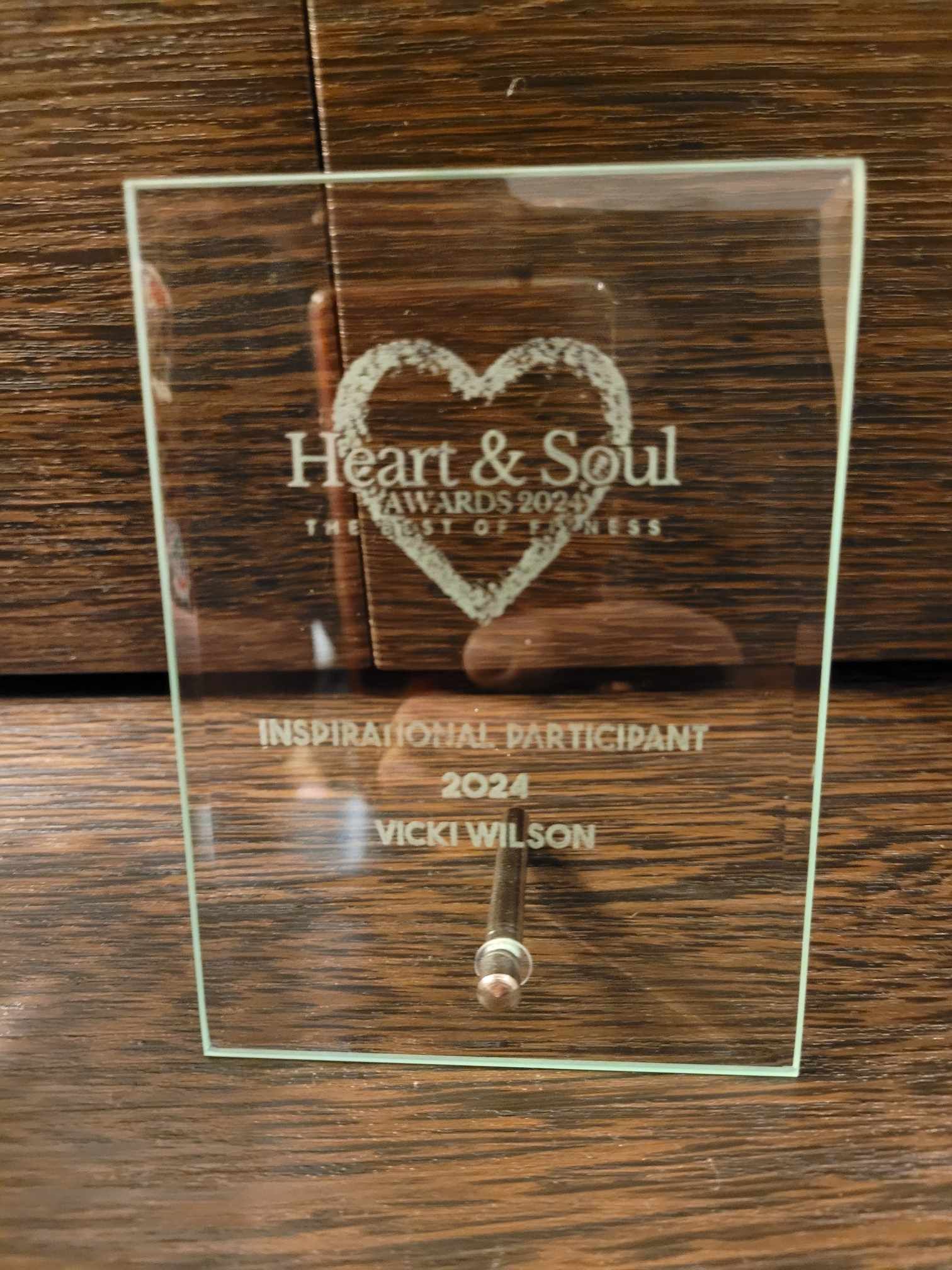 Square glass award. The words Heart & Soul sit in a love heart. Inspirational Participant is engraved underneath. 