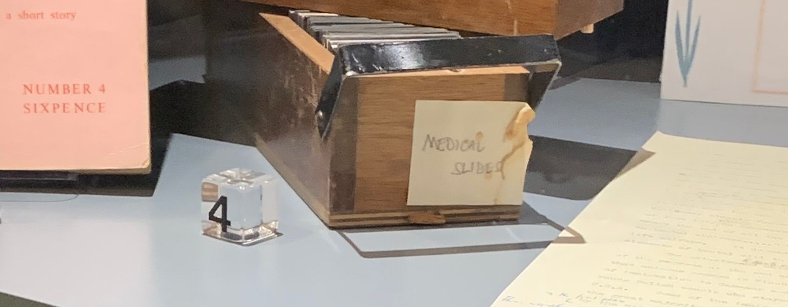 A brown box with medical slides written on a sticker with a number 4 block in front of it. 