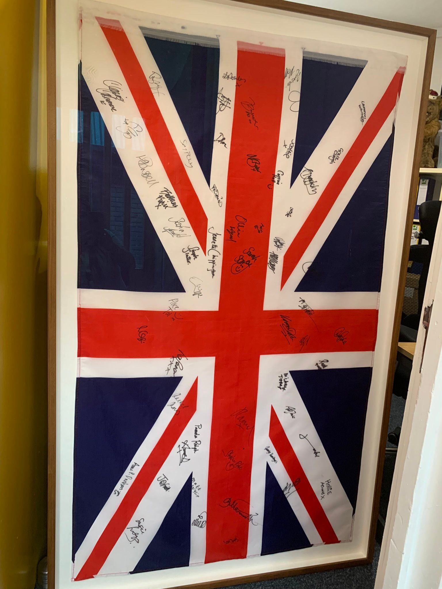 Union Jack flag of Red White and Blue with signatures all over from 2012 paralympians gold medalists.