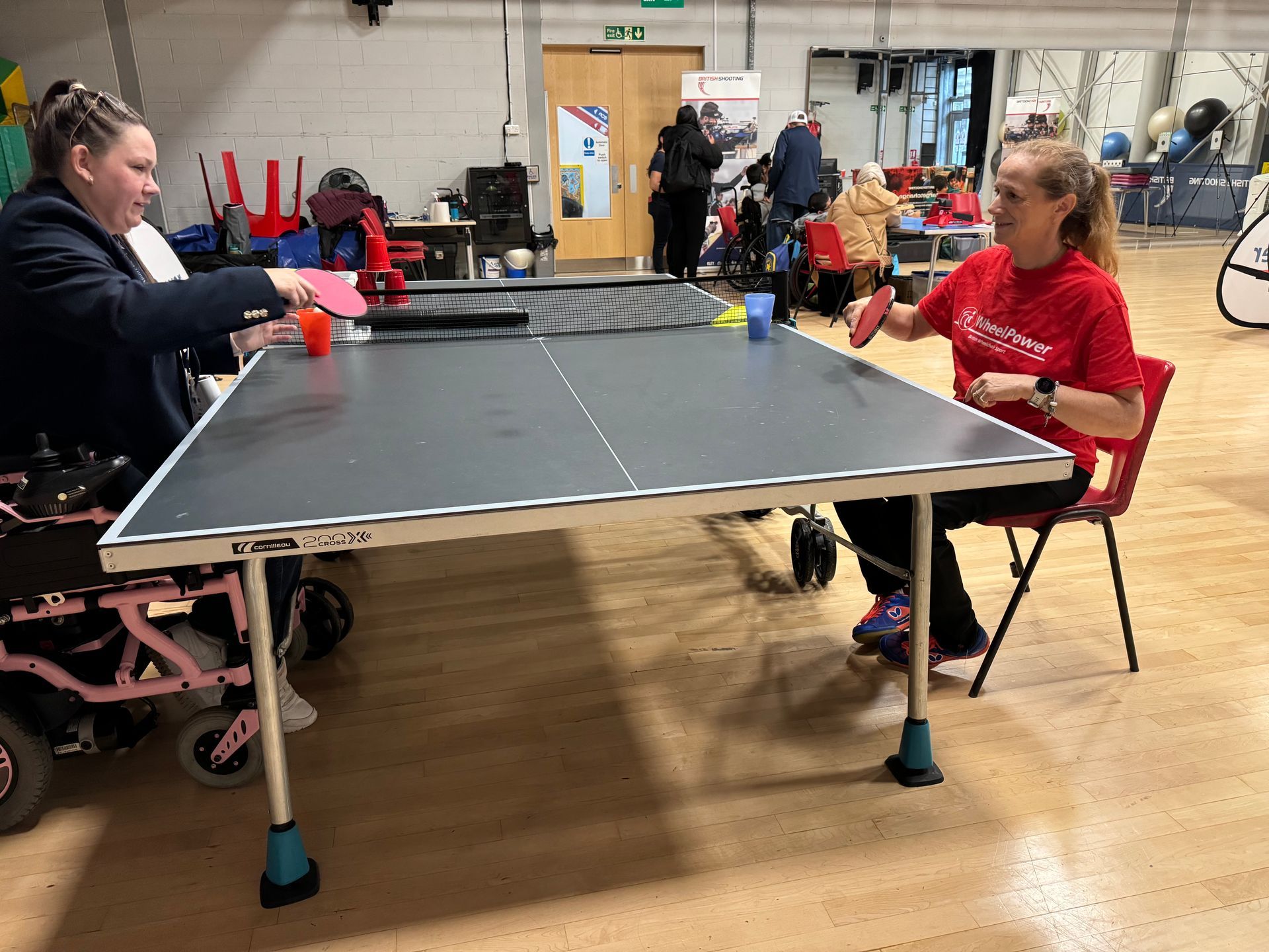 Table Tennis Table with participants at seat hight having a game. 