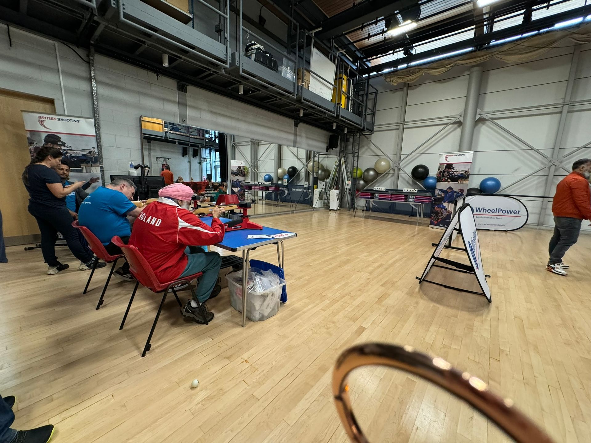 Participants taking part in inclusive shooting. A rest is being used to allow the gun to rest easy. 