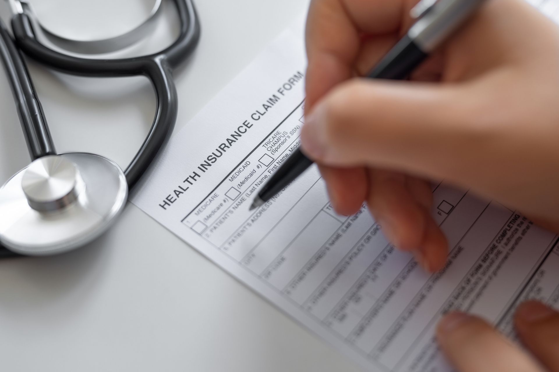Woman filling Health Insurance claim form Woman filling Health Insurance claim form
