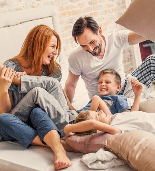 Term and Permanent Insurance — Happy Family Playing in Bed in Stevens Point,WI