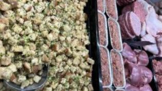 Two trays of food are sitting next to each other on a table.