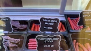 A display case filled with turkey sticks and traditional beef sticks.