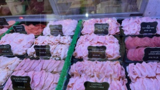 A display case filled with lots of different types of meat.