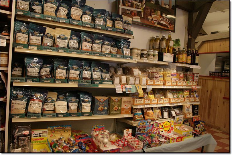 A store shelf filled with lots of bags of food
