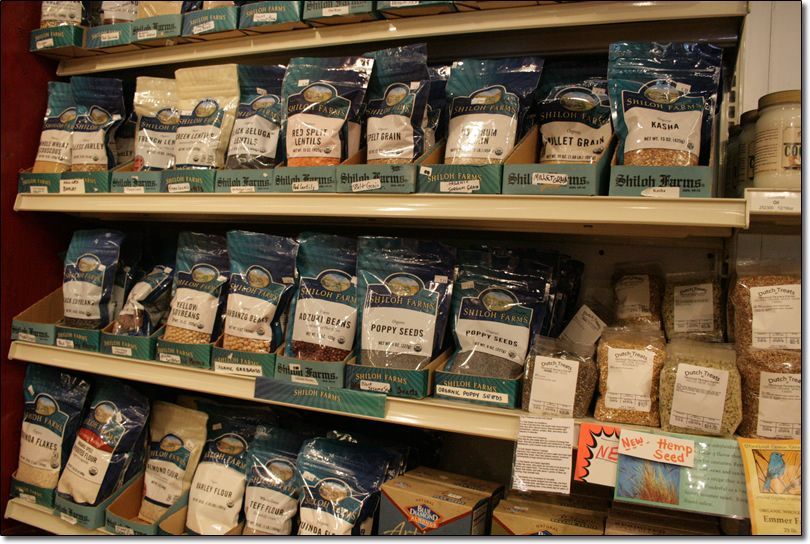 A store shelf filled with lots of bags of food