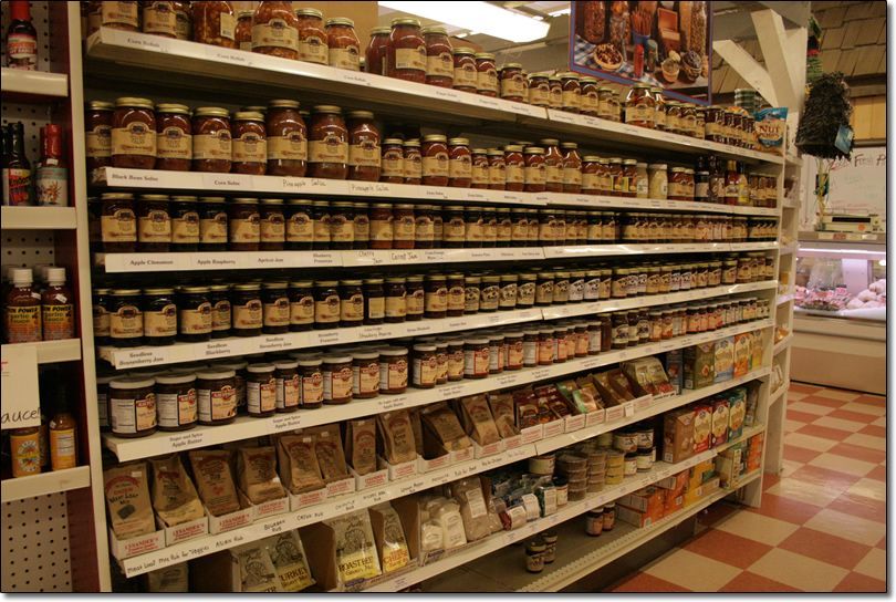 A grocery store aisle filled with jars and bags of food