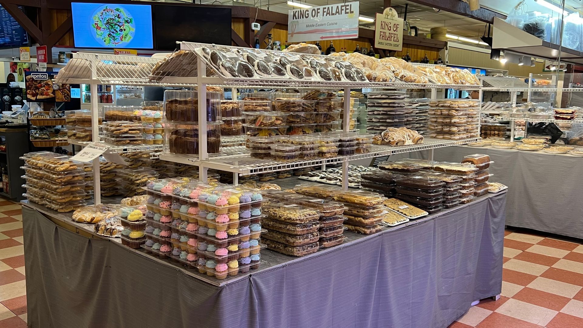 There are many different types of cookies on display in a bakery.