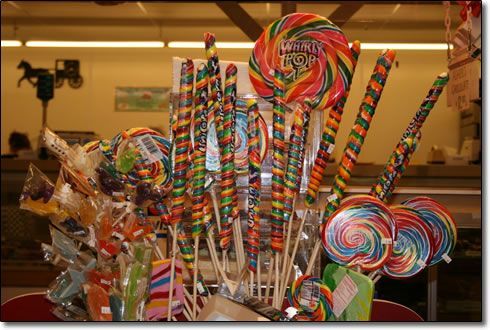 A bunch of colorful lollipops are on display in a store