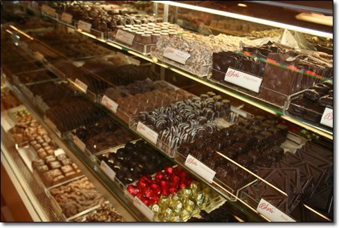 A display case filled with lots of different types of chocolates