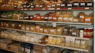 A grocery store shelf filled with lots of different types of food.