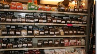 A store shelf filled with lots of different types of food.