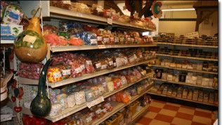 A grocery store aisle filled with lots of food and candy.