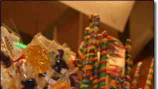A bunch of colorful lollipops are sitting on a table.
