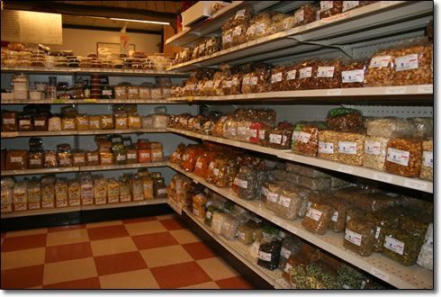 A grocery store aisle filled with lots of nuts and spices