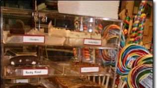 A display case filled with candy and lollipops in a store.