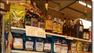 A store shelf filled with bottles and bags of food