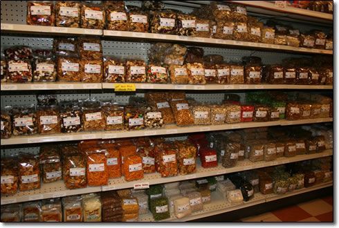 A grocery store shelf filled with bags of nuts