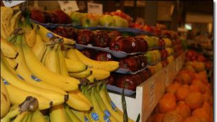 A bunch of bananas are stacked on top of each other in a fruit stand.