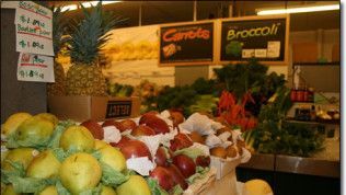 A variety of fruits and vegetables are on display in a grocery store