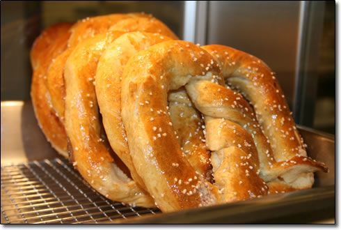 A bunch of pretzels are sitting on a cooling rack
