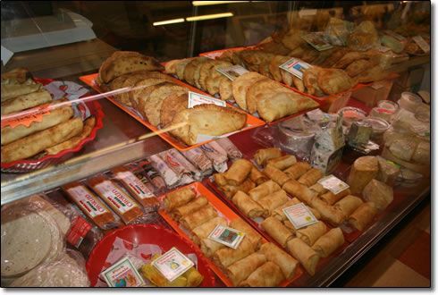 A display case filled with a variety of food items