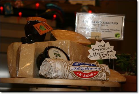A display of cheeses with a sign that says amsterdam on it