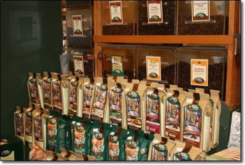 A bunch of bags of coffee are lined up on a shelf