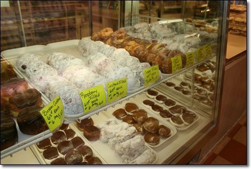 A display case filled with a variety of donuts and pastries