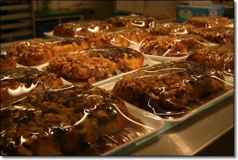 A bunch of cinnamon rolls are wrapped in plastic