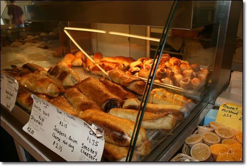 A variety of pastries are displayed in a glass case.