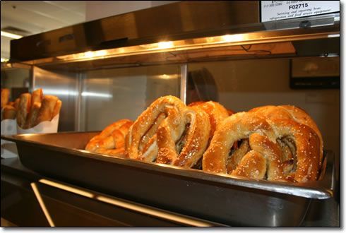 A bunch of pretzels are sitting in a metal tray