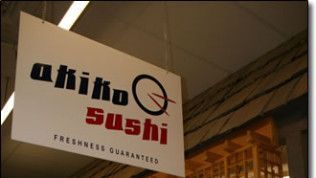 A sign for a sushi restaurant hangs from the ceiling.