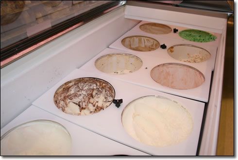 A display case filled with different flavors of ice cream