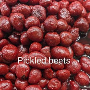 A pile of pickled beets sitting on top of a table.