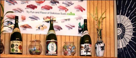 Several bottles of alcohol are lined up on a wooden shelf