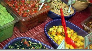 A table topped with bowls of different types of food.