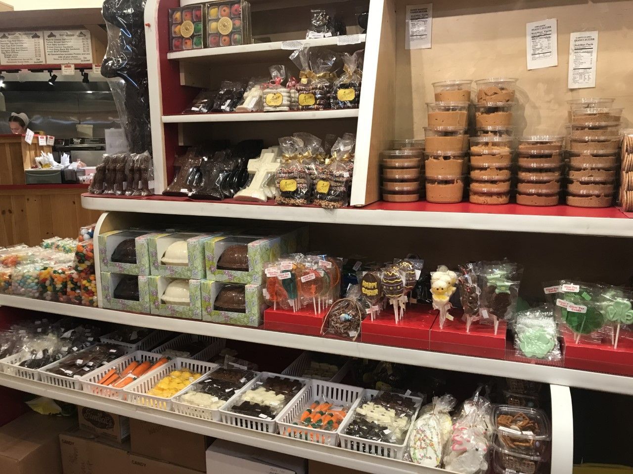 There are many different types of candy on the shelves in this store.