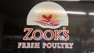 Zook 's fresh poultry logo on a black background