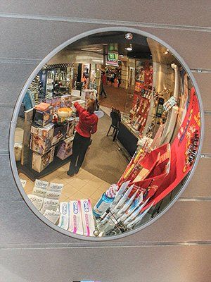 Economy indoor convex mirror used for surveillance in shop.